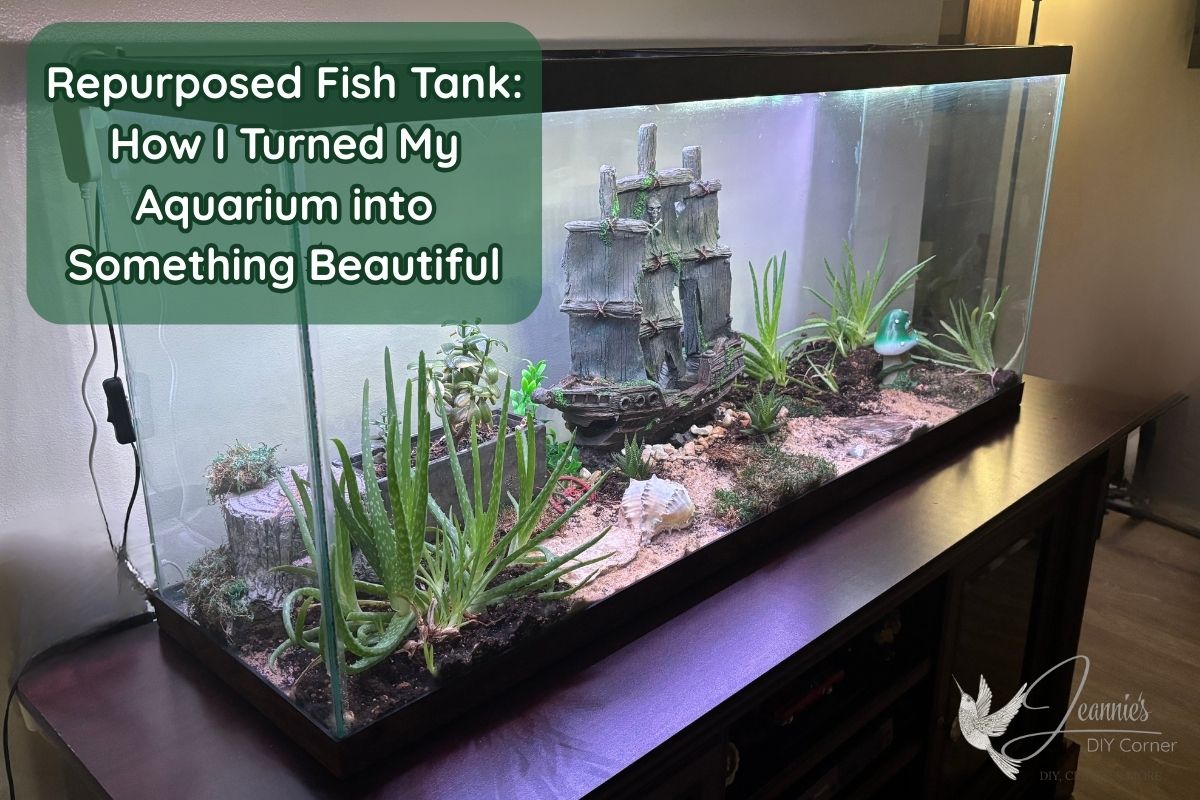 banner reads repurposed fish tank - how I turned my aquarium into something beautiful. In the background of the photo you see a pirate ship decoration, plants, and a mushroom fairy home, all inside of a fish tank